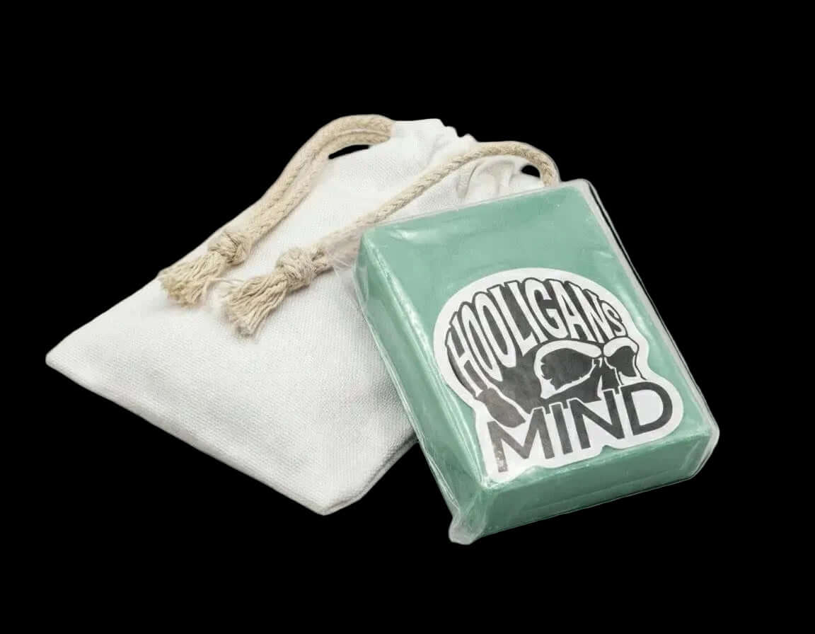 Green wax bar  with 'Hooligan's Mind' branding and a white drawstring bag.